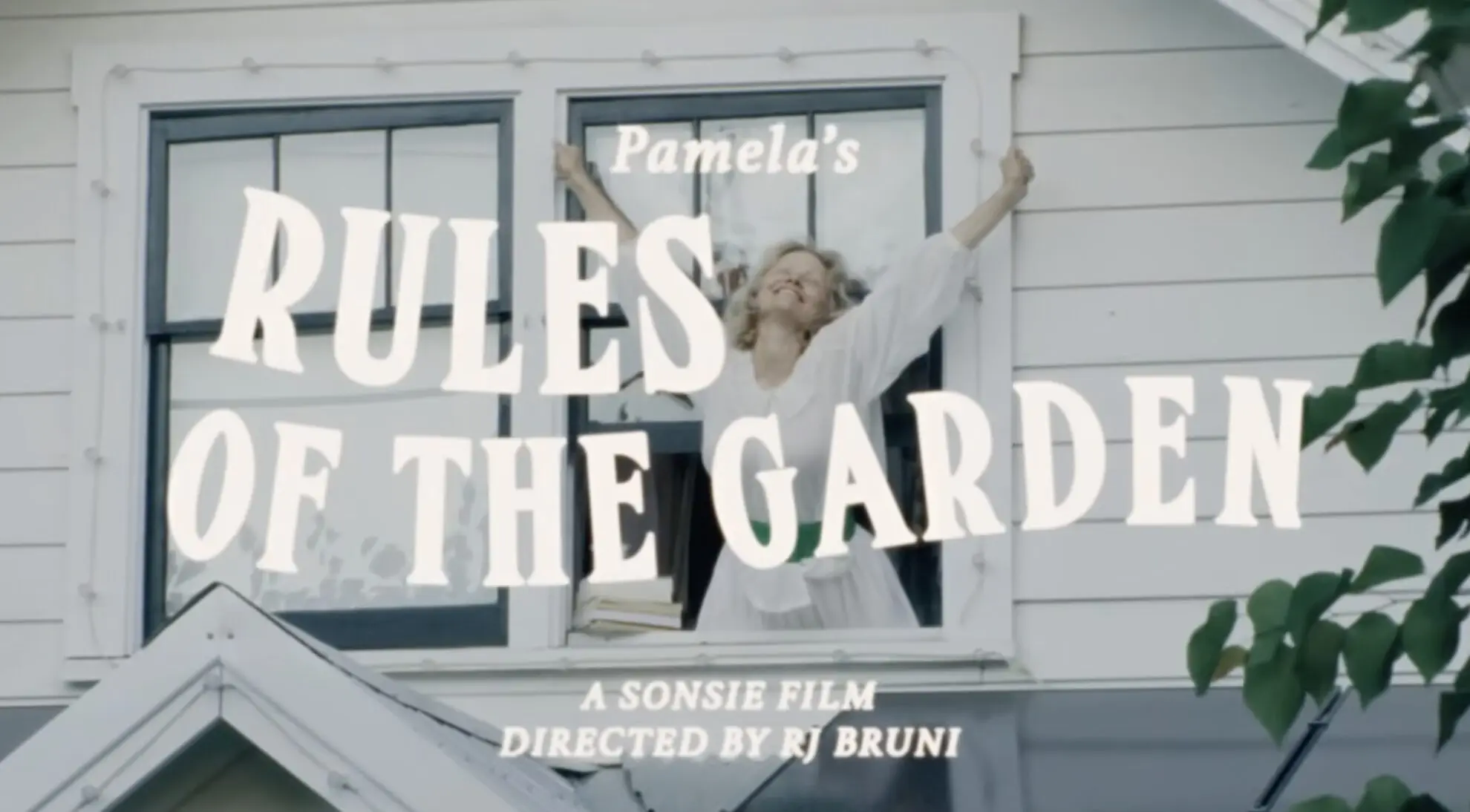 a screenshot of a commercial with pamela anderson for sonsie skin where she is stretching and waking up from her house.