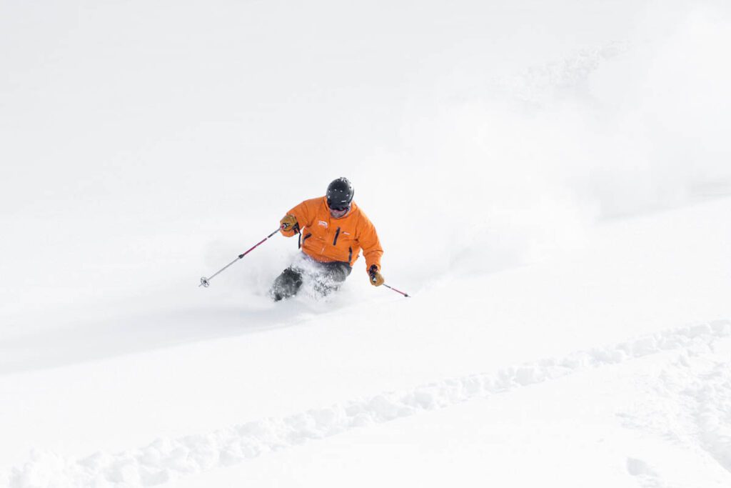 a skier in an open powder slope enjoying himself in the snow