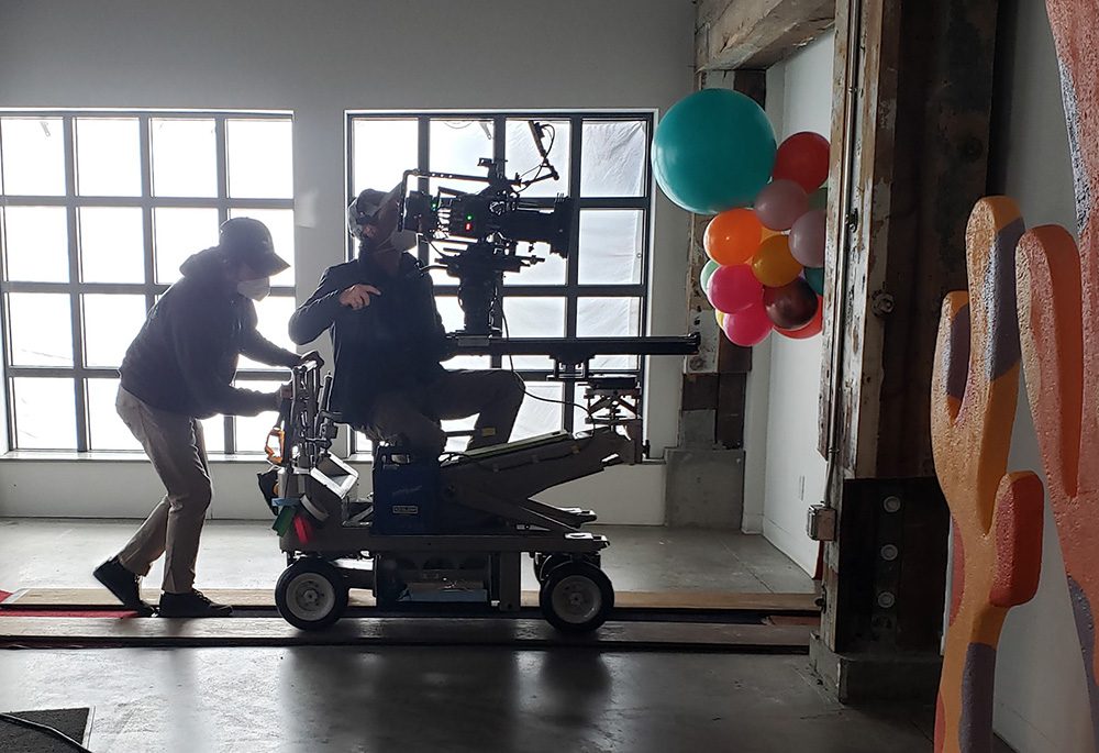 a camera crew on a dolly while filming a production in vancouver, british columbia